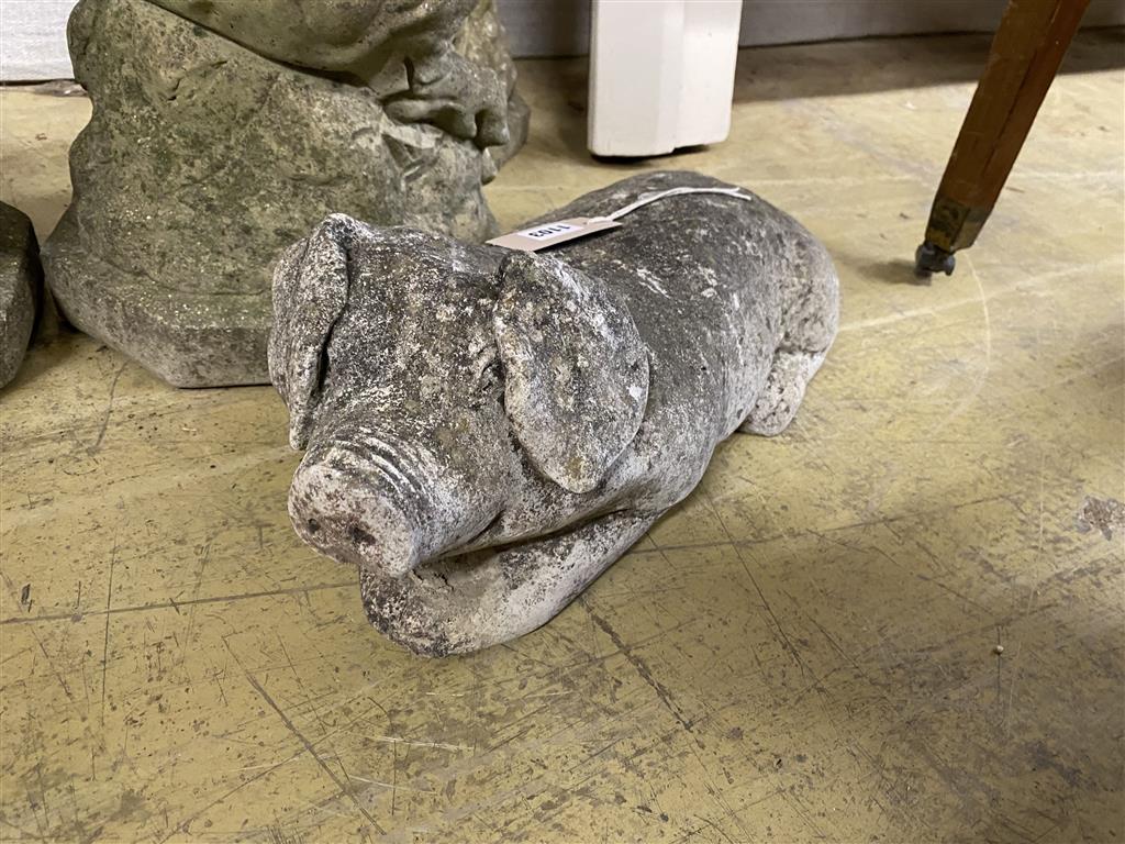 Four reconstituted stone garden ornaments, modelled as pigs, largest 60cm high